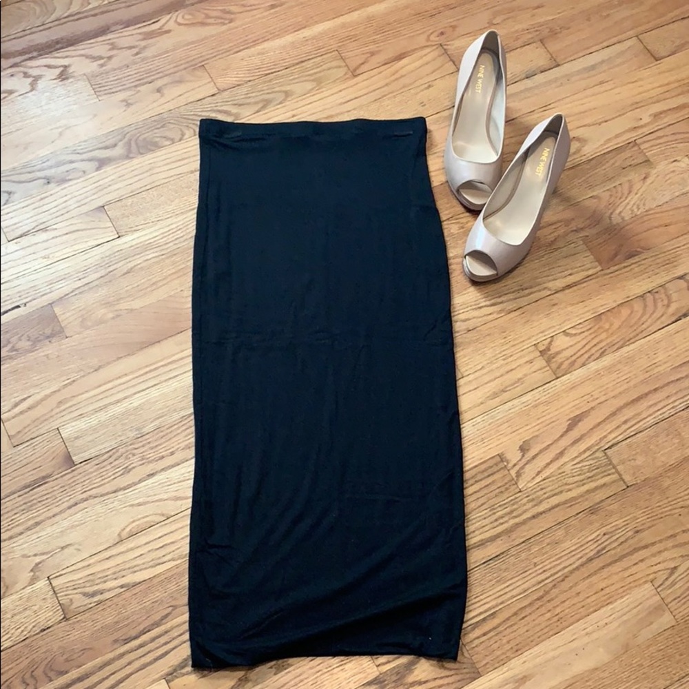 Long black skirt. Form fitting.